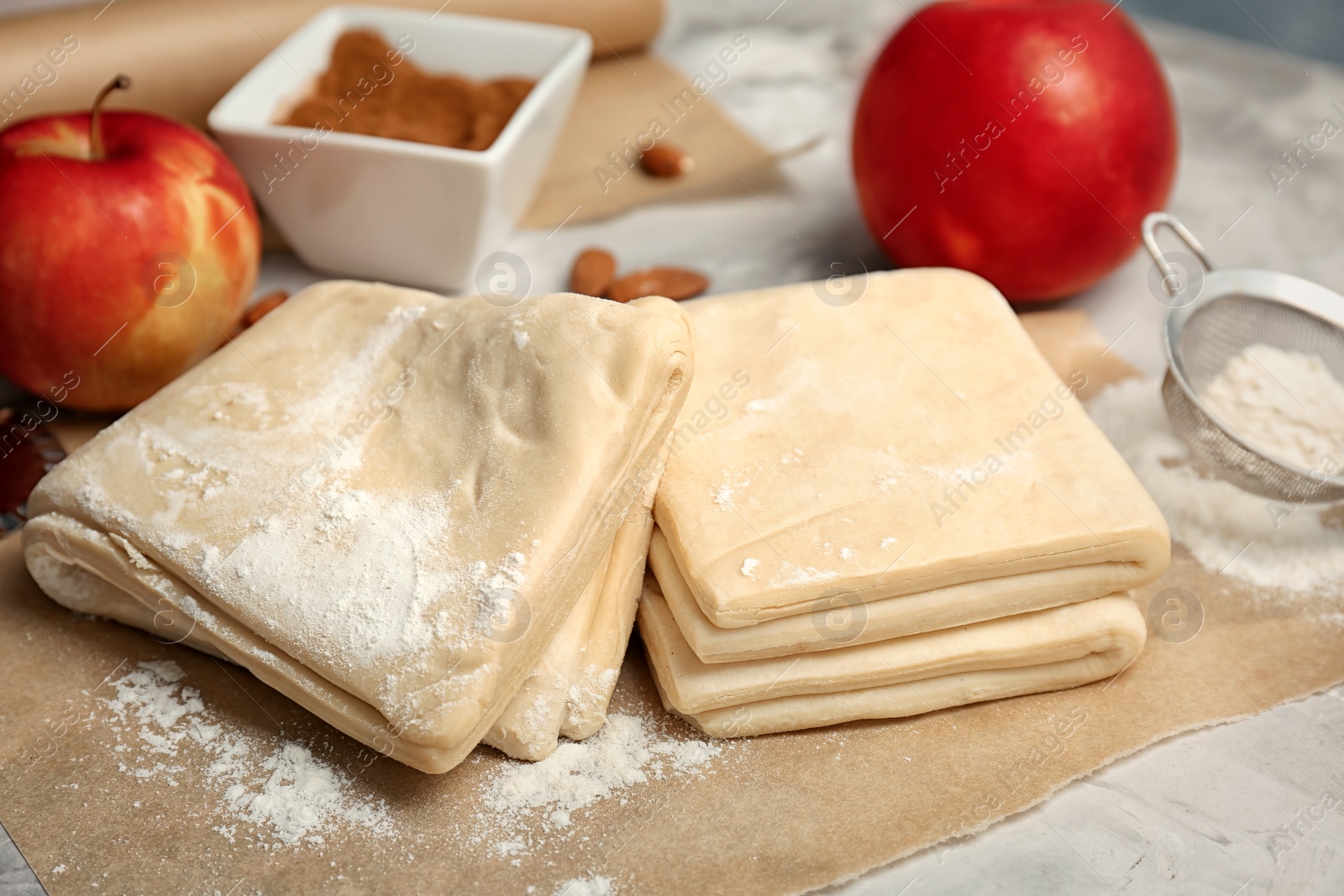 Photo of Raw flaky dough and ingredients on table