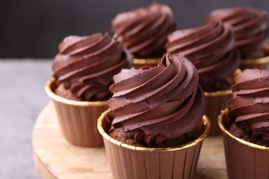 Photo of Delicious chocolate cupcakes on grey table, closeup