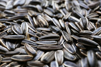 Photo of Pile of sunflower seeds as background, closeup