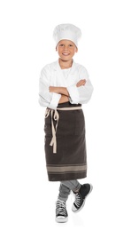 Full length portrait of little boy in chef hat on white background