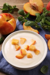 Photo of Delicious yogurt with fresh peach on table