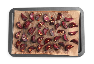 Photo of Baking tray with roasted beetroot slices on white background, top view