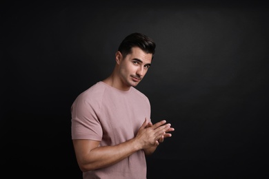 Portrait of handsome young man on black background