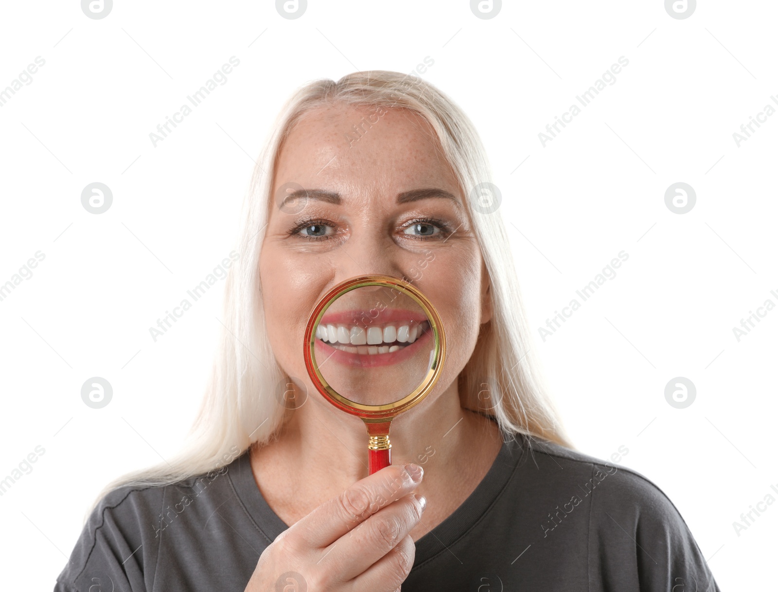 Photo of Smiling woman with perfect teeth and magnifier on white background