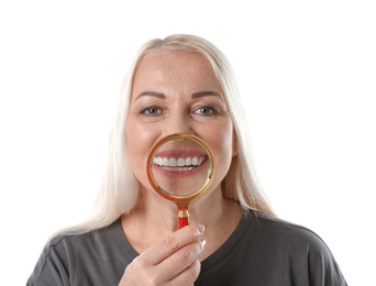 Photo of Smiling woman with perfect teeth and magnifier on white background