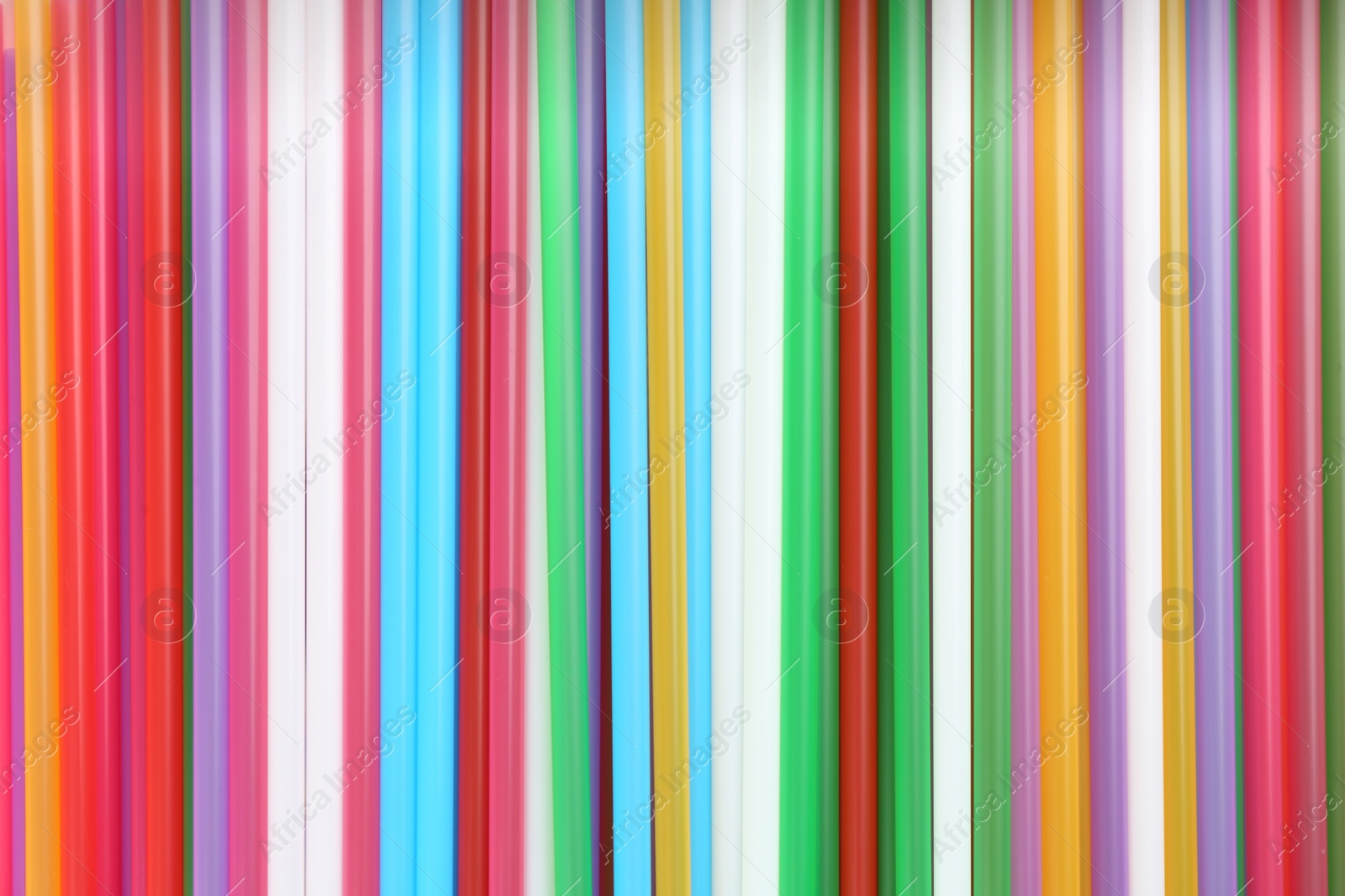 Photo of Heap of colorful plastic straws for drinks as background, closeup