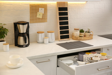 Photo of Stylish kitchen interior with modern coffeemaker on countertop