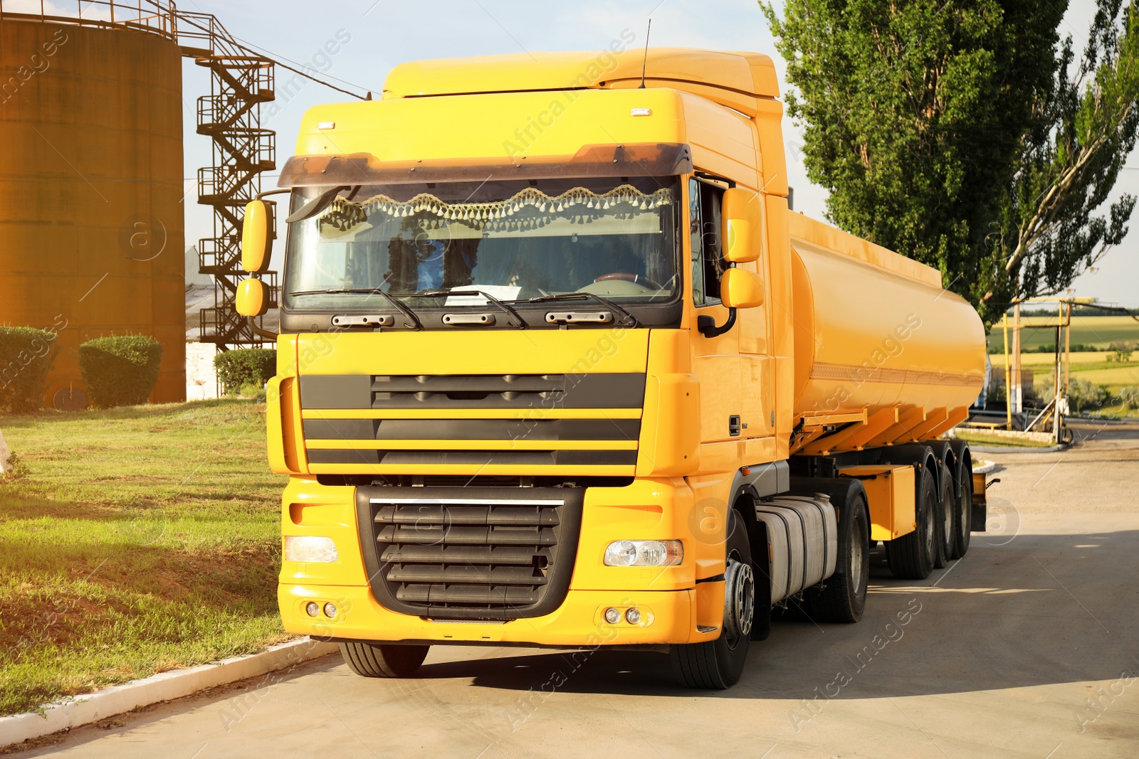 Photo of Modern yellow truck parked on country road