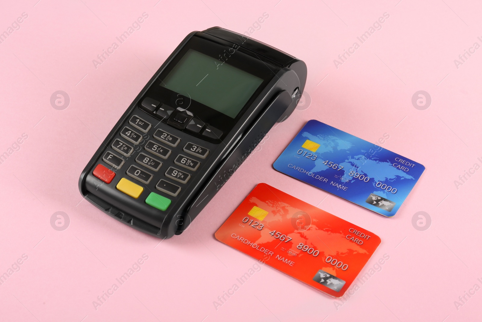 Photo of New modern payment terminal and credit cards on pink background