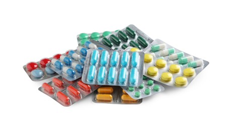 Photo of Pile of different pills in blister packs on white background