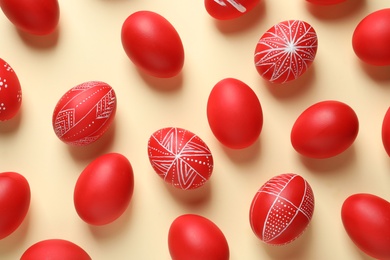 Photo of Flat lay composition of red painted Easter eggs on color background