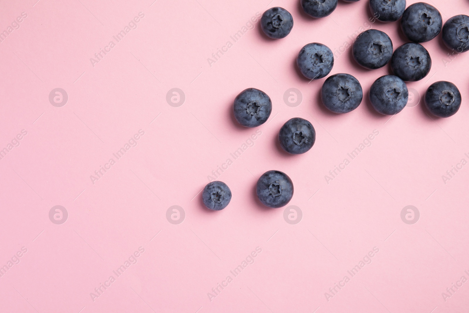 Photo of Flat lay composition with tasty blueberry and space for text on color background