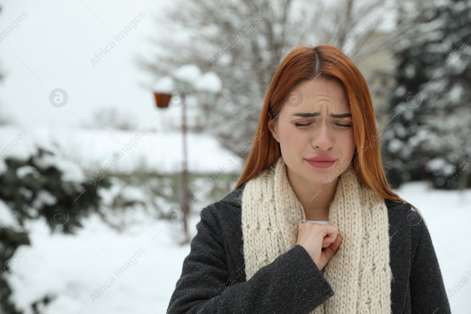 Photo of Beautiful young woman coughing outdoors, space for text. Cold symptoms