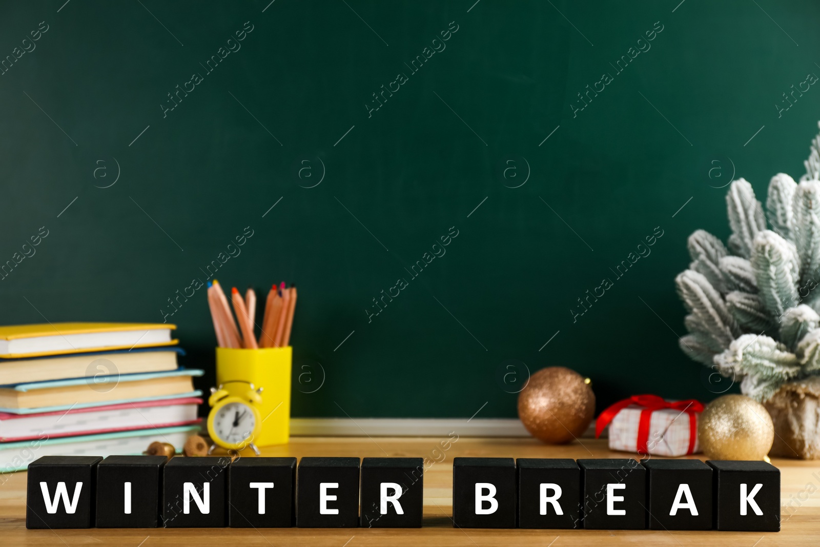 Photo of Black cubes with phrase Winter Break on wooden table, space for text. Holidays concept