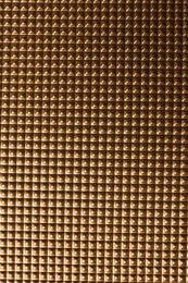 Textured golden surface as background, top view