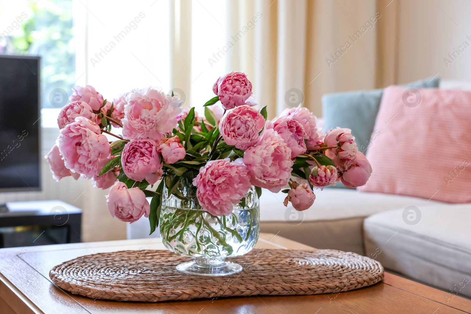 Photo of Beautiful pink peonies in vase on table at home. Interior design