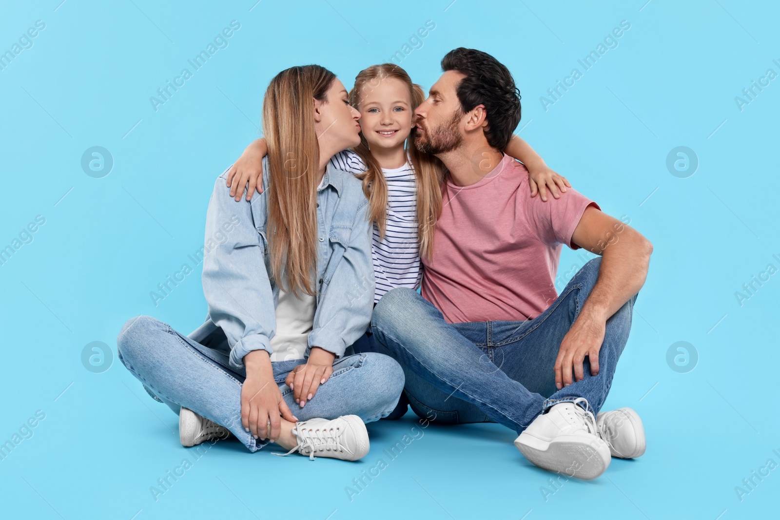 Photo of Happy family together on light blue background