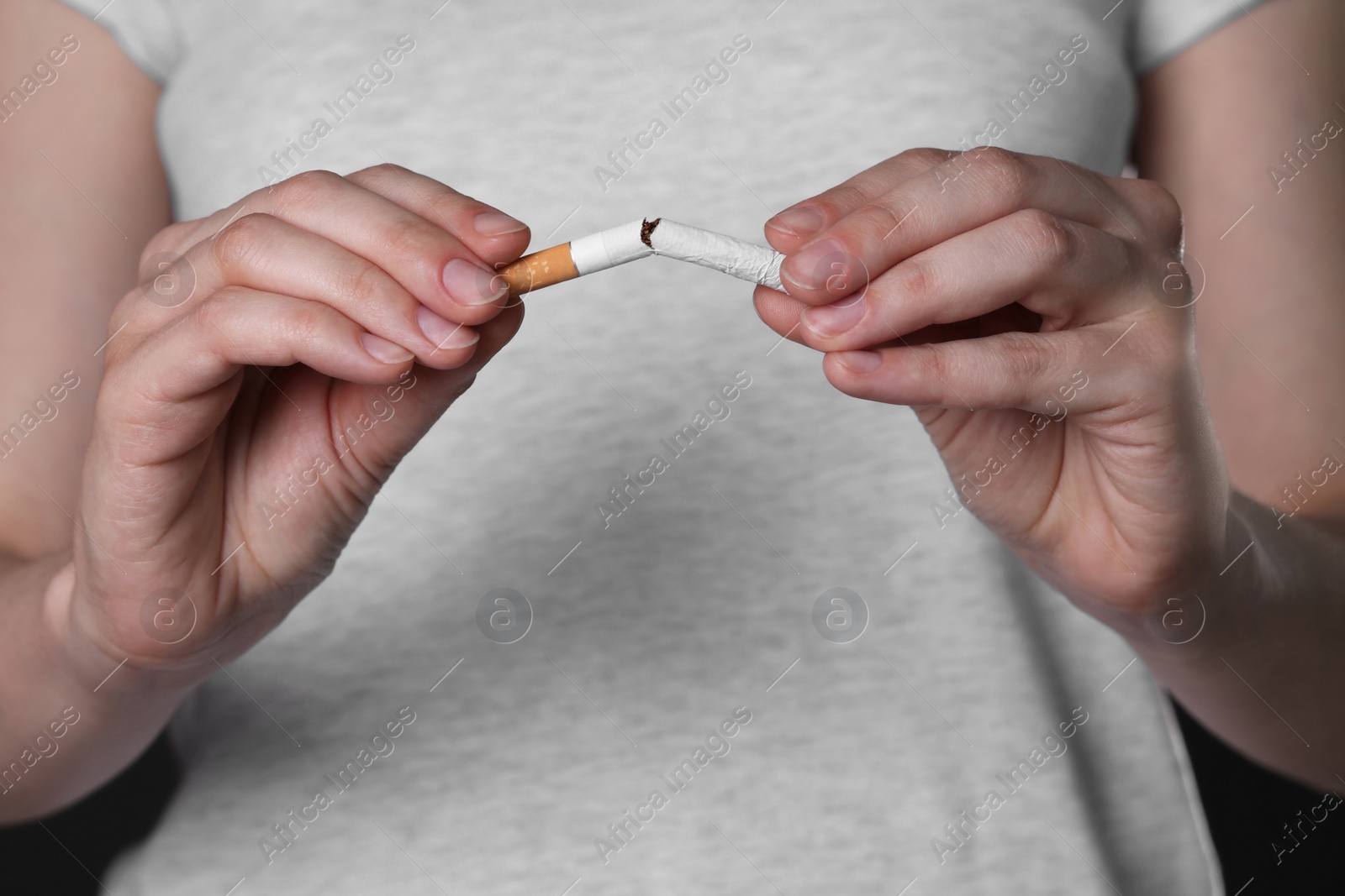 Photo of Stop smoking concept. Woman breaking cigarette, closeup