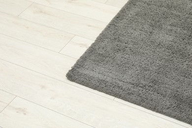 Soft grey carpet on white laminated floor indoors, space for text