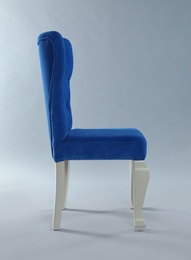 Photo of Stylish blue chair on light grey background. Element of interior design
