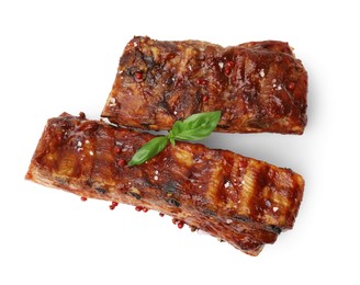Photo of Tasty roasted pork ribs, basil and peppercorns isolated on white, top view