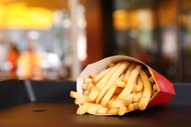 Photo of MYKOLAIV, UKRAINE - AUGUST 11, 2021: Big portion of McDonald's French fries on tray in cafe. Space for text