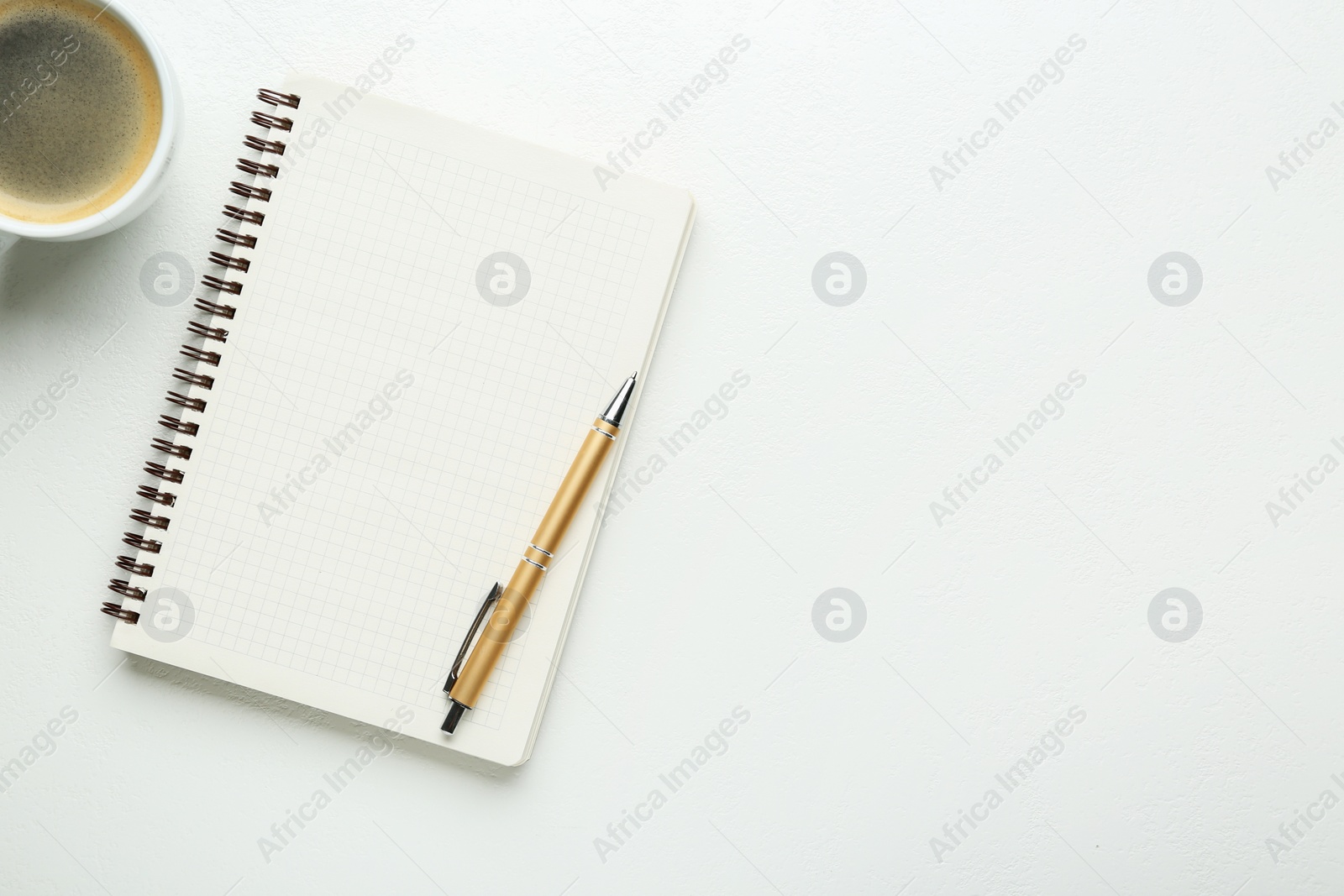 Photo of Notebook, coffee and pen on white table, flat lay. Space for text