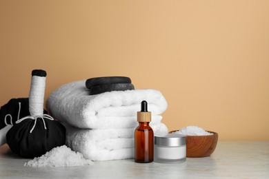 Photo of Composition with different spa products on beige table. Space for text