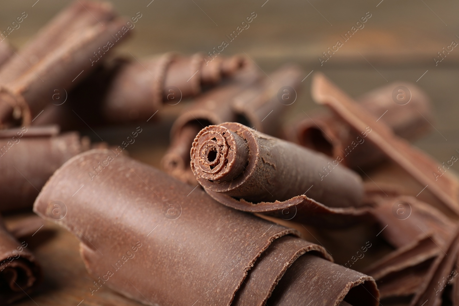 Photo of Chocolate curls for decor on table, closeup