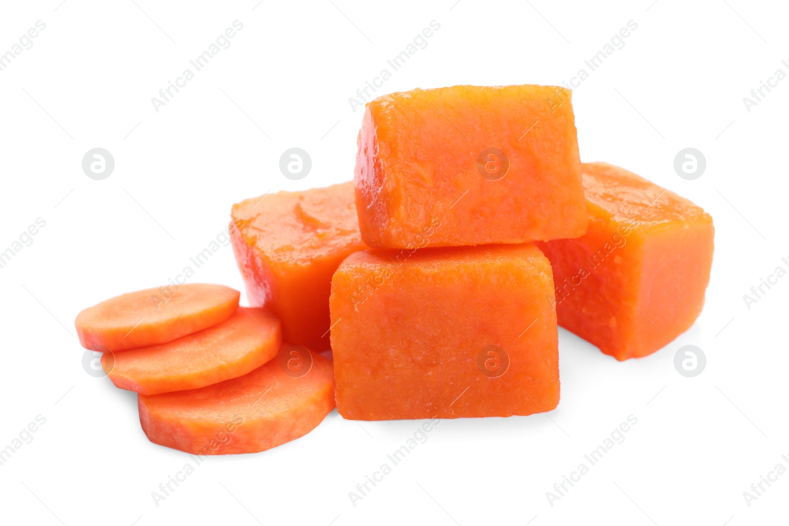 Photo of Frozen carrot puree cubes and fresh carrot isolated on white