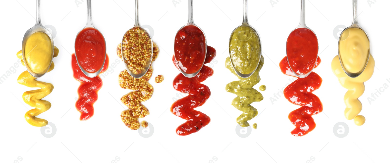 Image of Set of spoons with different delicious sauces on white background, top view. Banner design