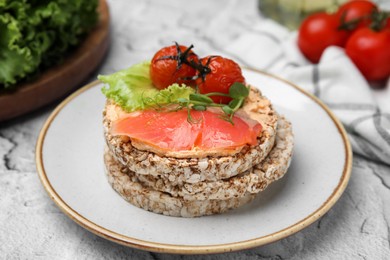 Photo of Crunchy buckwheat cakes with salmon, tomatoes and greens on table
