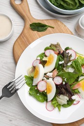 Photo of Delicious salad with boiled egg, radish and cheese served on white wooden table, flat lay