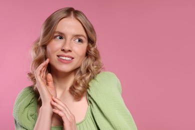 Photo of Portrait of beautiful woman with blonde hair on pink background. Space for text