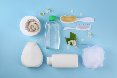 Photo of Baby care products and accessories on light blue background, flat lay