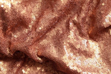 Photo of Beautiful golden shiny cloth with sequins as background, top view