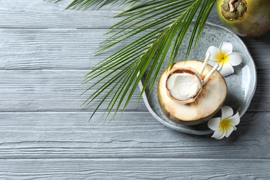 Photo of Beautiful composition with fresh green coconut on wooden background, top view