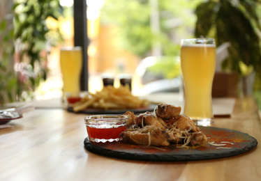 Tasty BBQ wings served on table in cafe