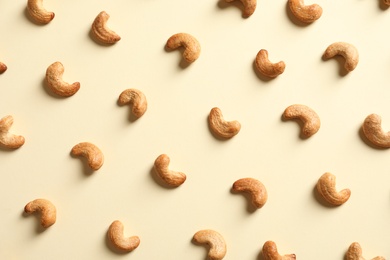 Photo of Tasty cashew nuts on light background, flat lay