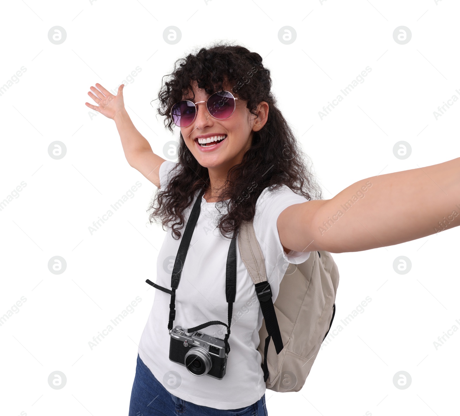 Photo of Beautiful woman in sunglasses with camera taking selfie on white background