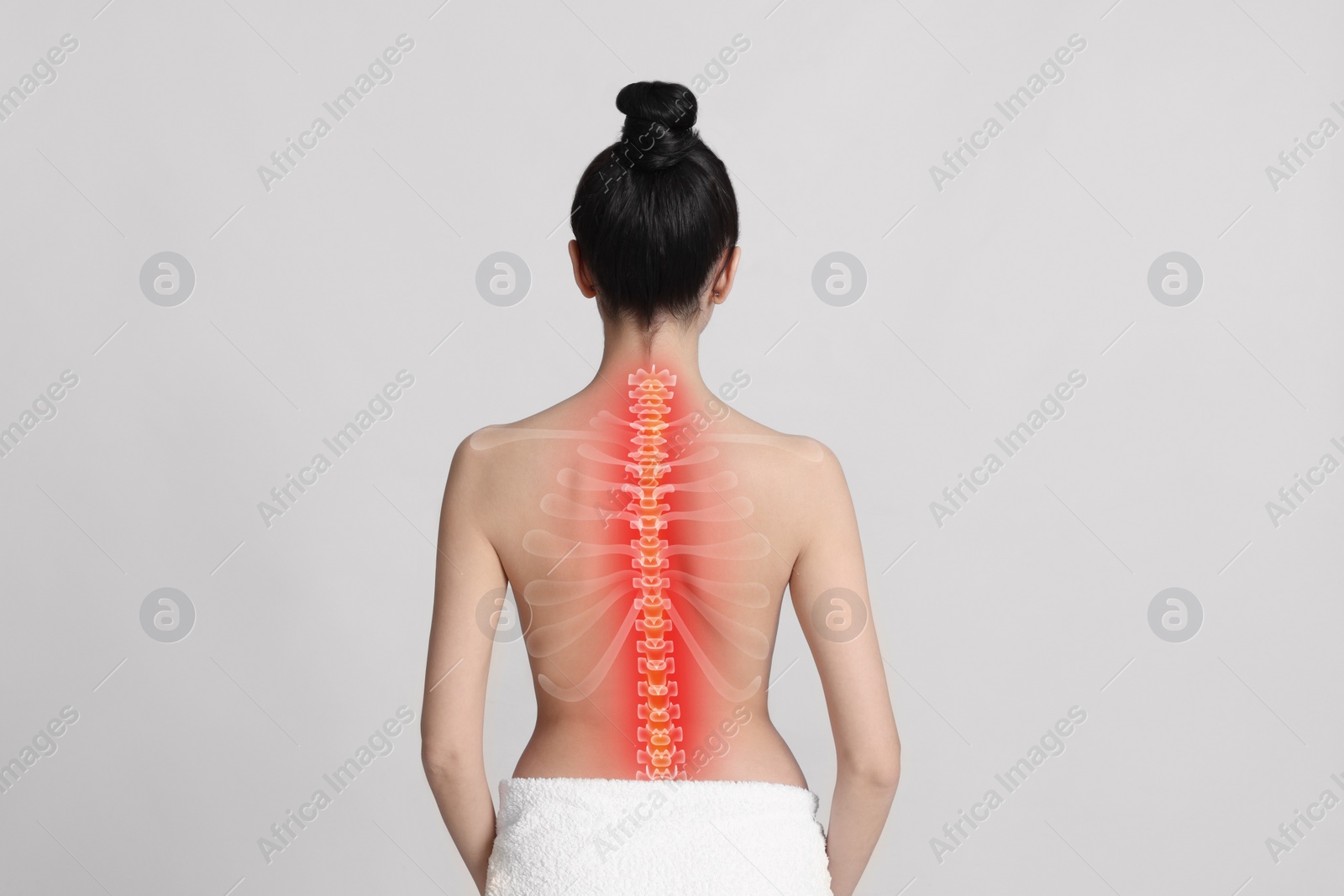 Image of Woman suffering from pain in neck on light grey background