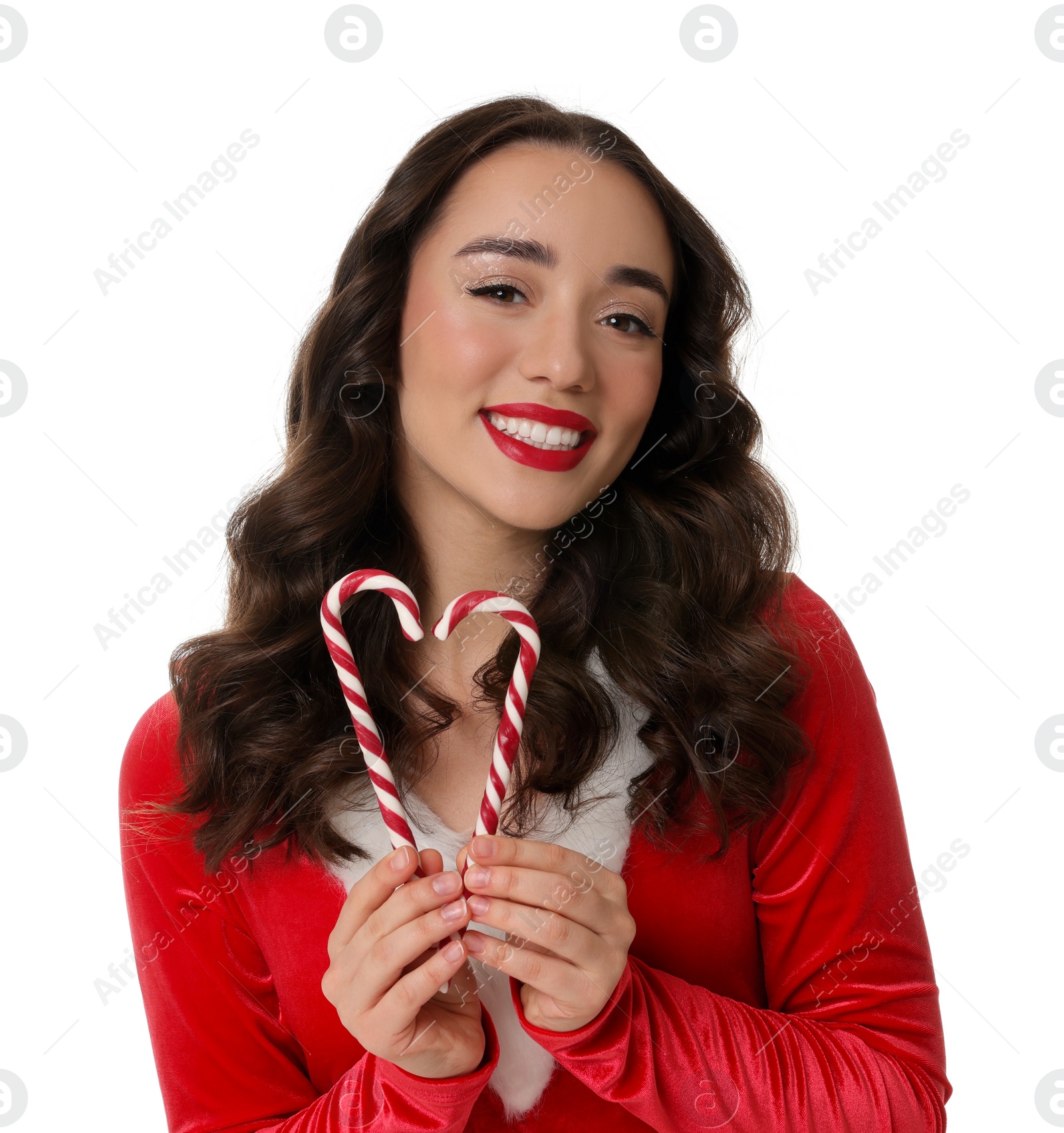 Photo of Beautiful young woman in Christmas red dress and candy canes isolated on white