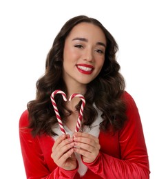 Beautiful young woman in Christmas red dress and candy canes isolated on white