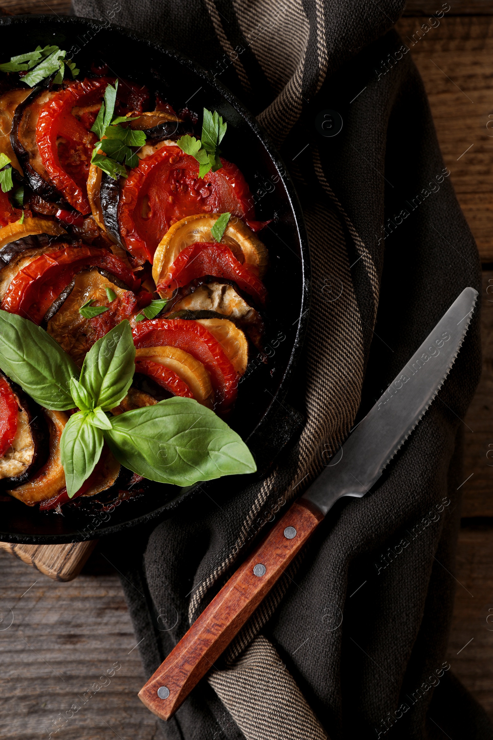 Photo of Delicious ratatouille and knife on table, flat lay