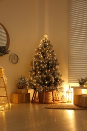 Beautiful decorated Christmas tree in festive room interior