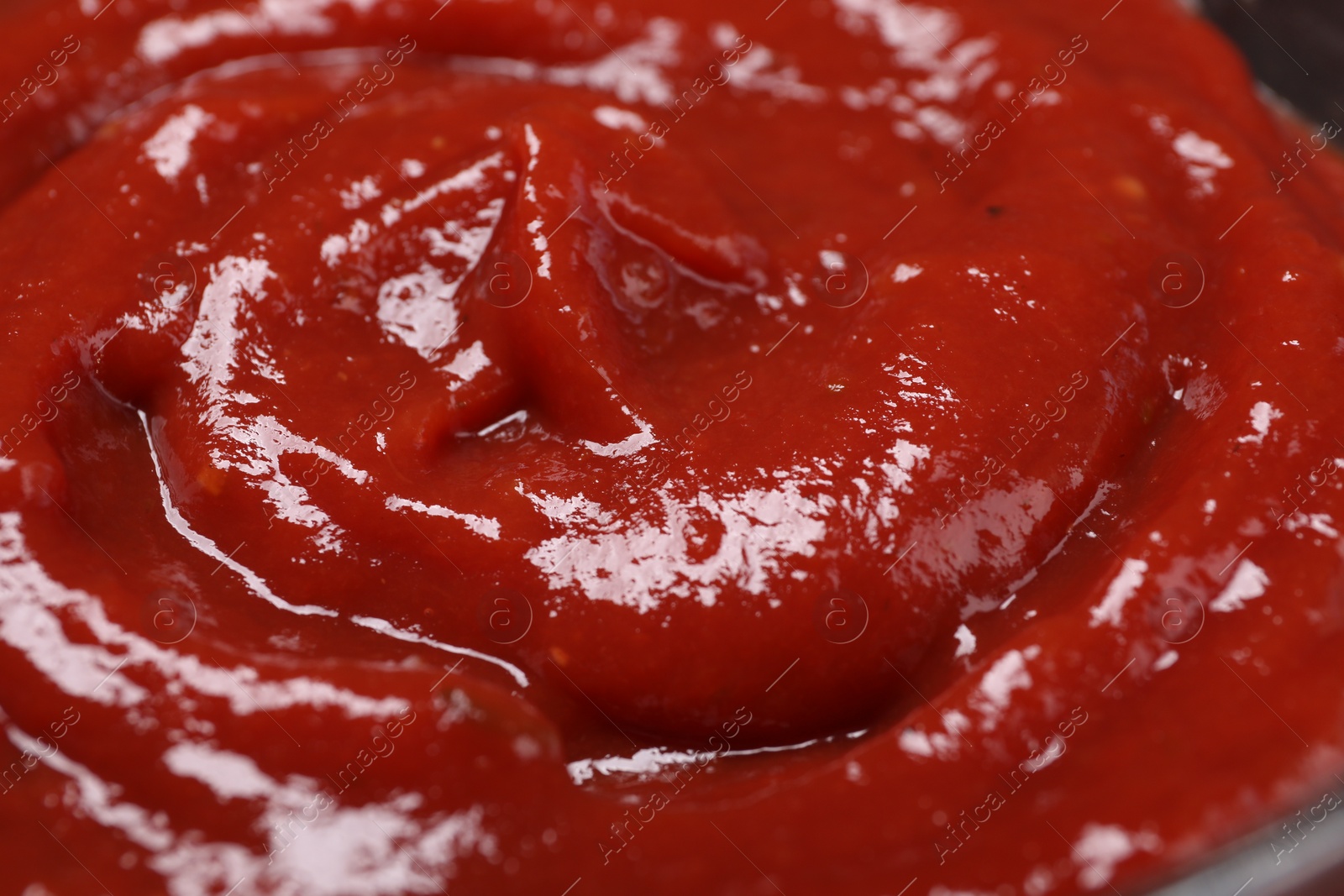 Photo of Organic ketchup as background, closeup. Tomato sauce