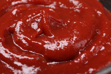 Photo of Organic ketchup as background, closeup. Tomato sauce