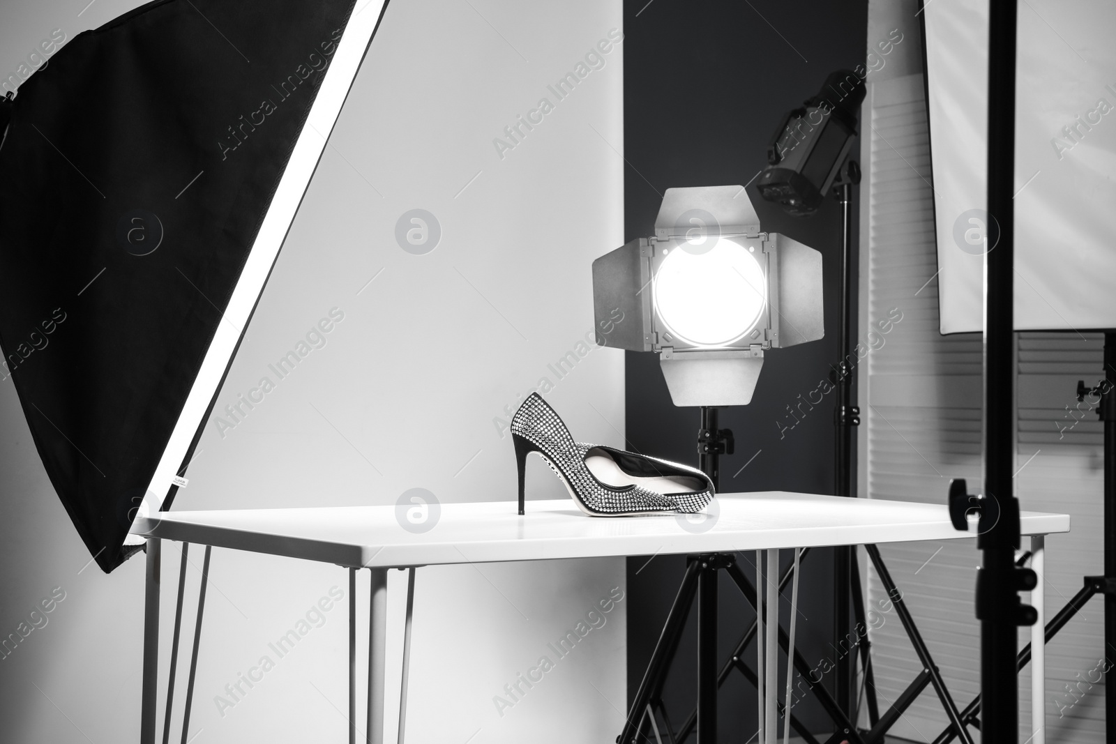 Photo of Professional photography equipment prepared for shooting stylish shoes in studio