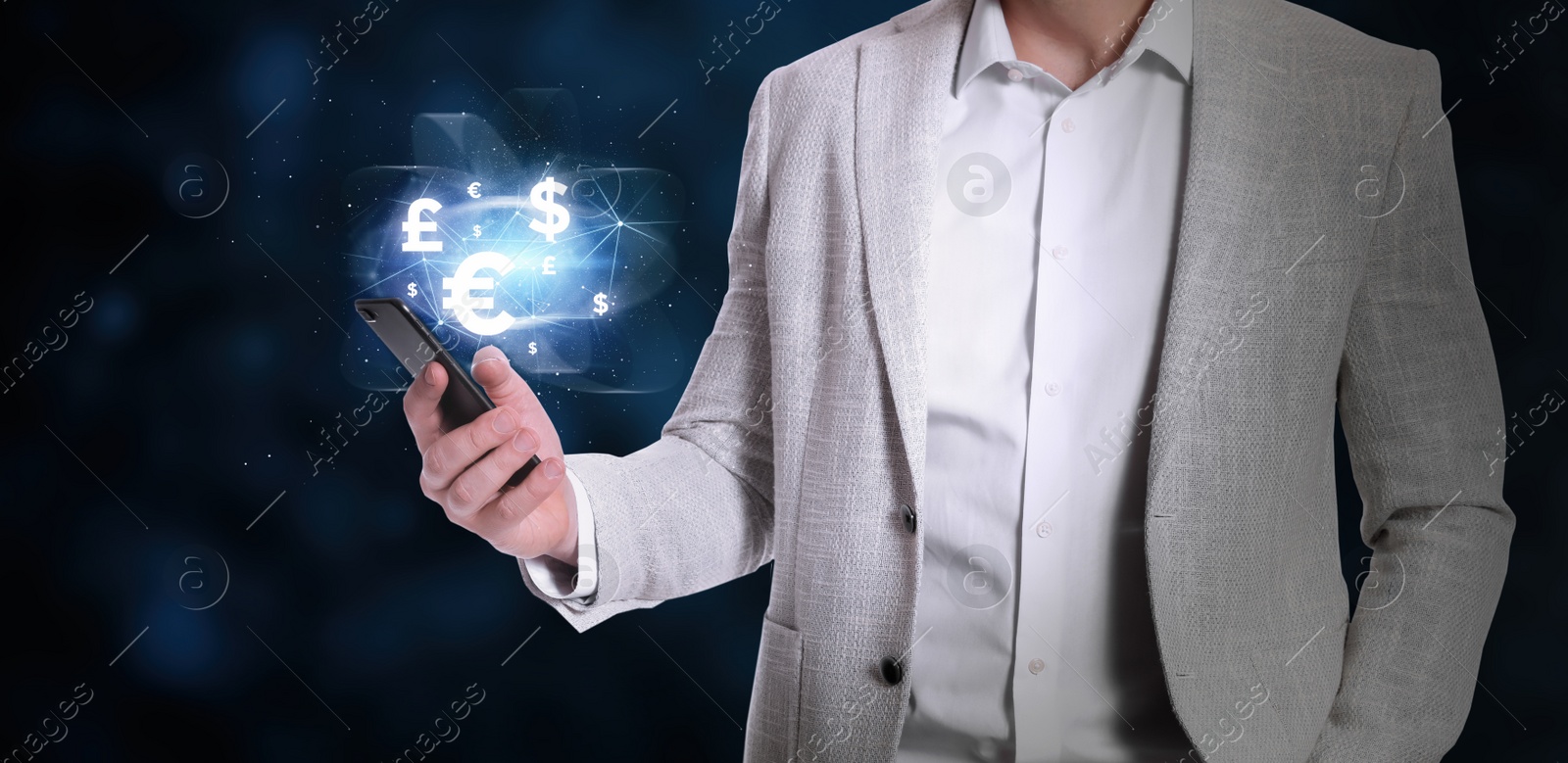 Image of Fintech concept. Man with smartphone on dark background, closeup