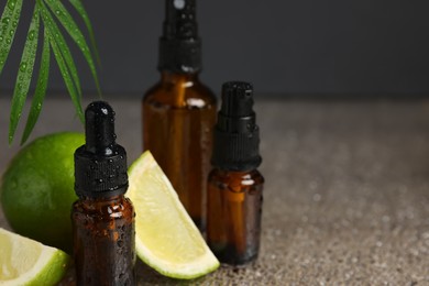 Photo of Bottles of organic cosmetic products and sliced lime on wet surface, closeup